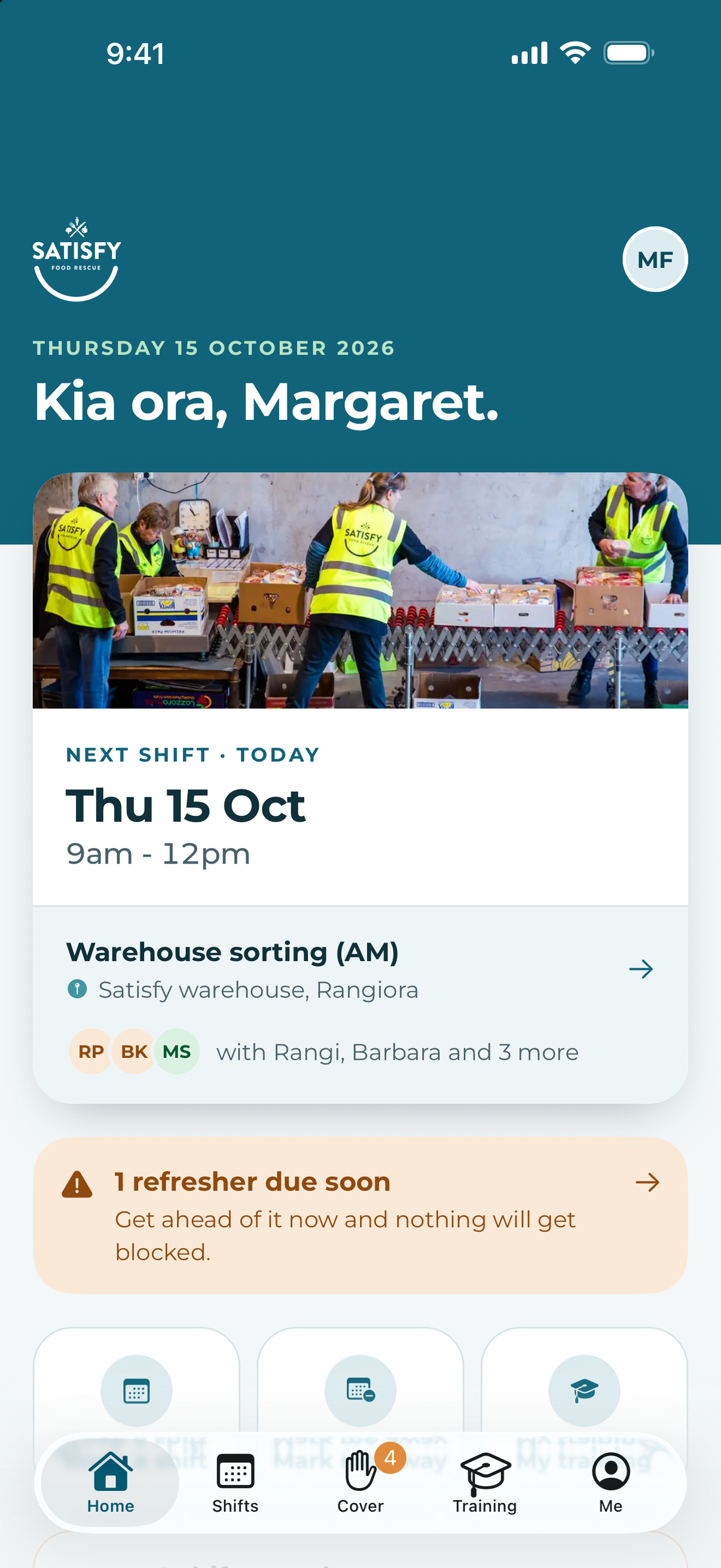 Satisfy volunteer app home screen: 'Kia ora, Margaret.', the next shift with who else is on it, and a banner saying a refresher is due soon